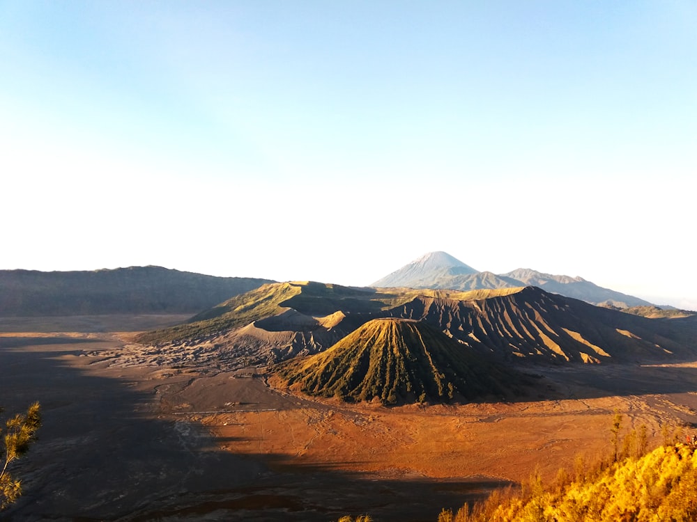 brown and black mountain under white clouds during daytime