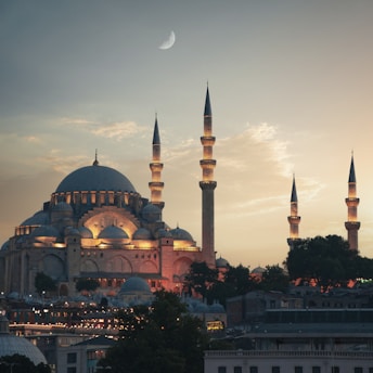 a large building with two towers and a crescent in the sky