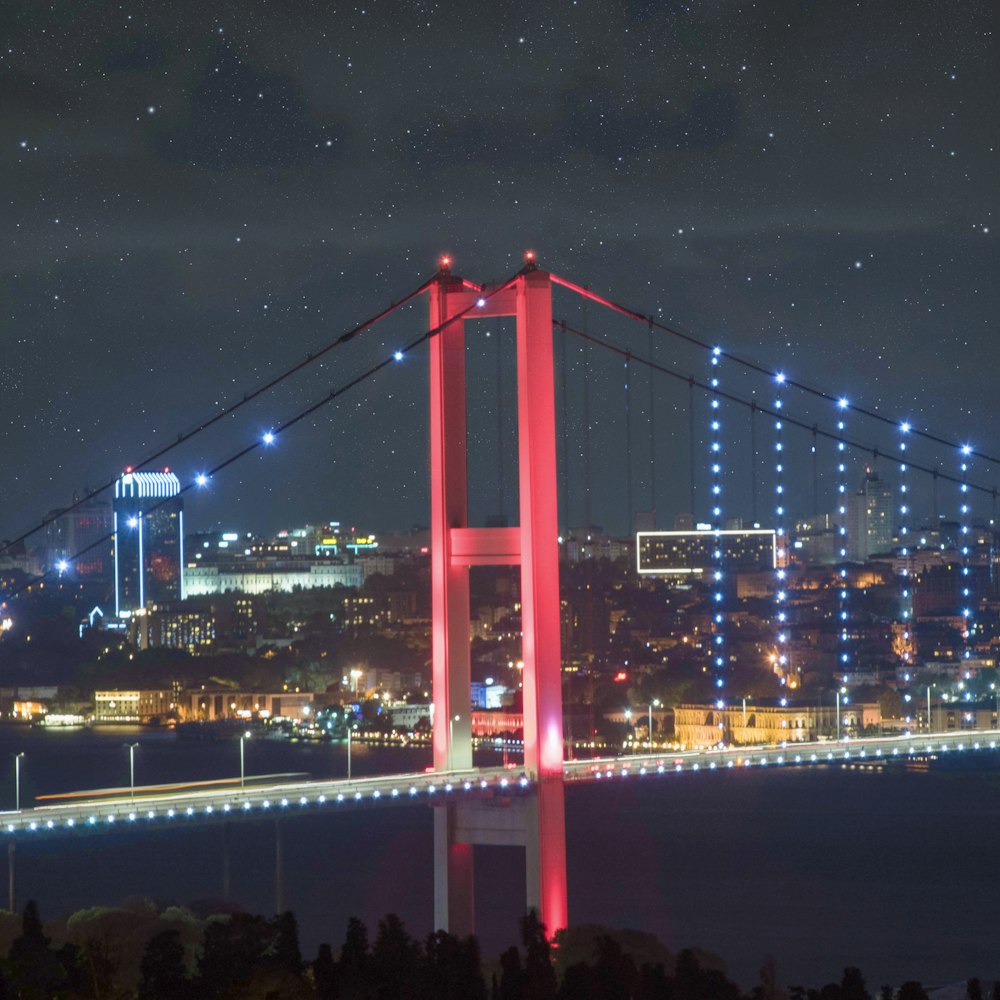 a night view of a bridge with lights on it