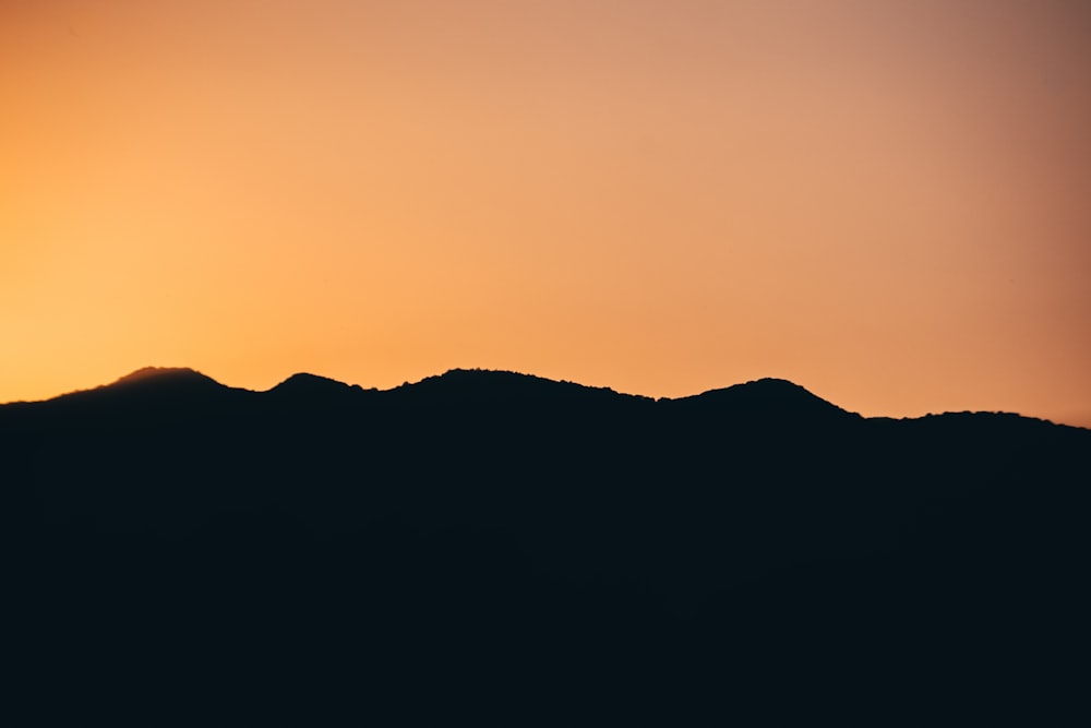 silhouette of mountain during sunset