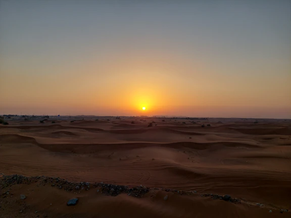 Sunset over the golden dunes of Merzouga in the Sahara Desert.
