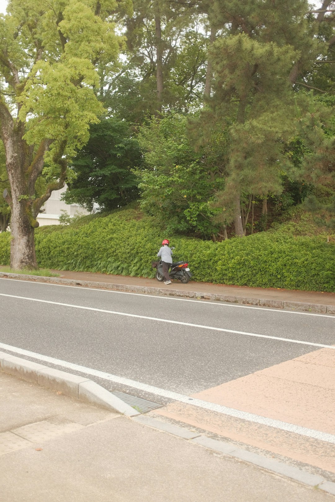 man in black jacket riding bicycle on gray concrete road during daytime