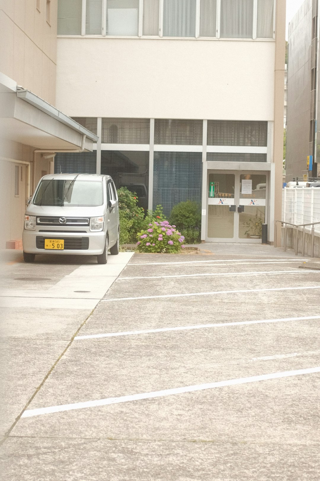 white van parked in front of white building