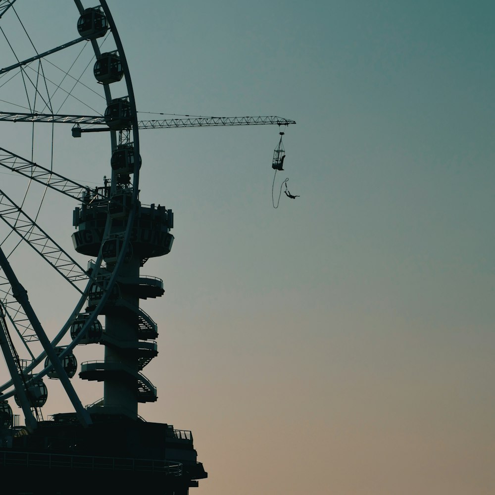 black ferris wheel under gray sky