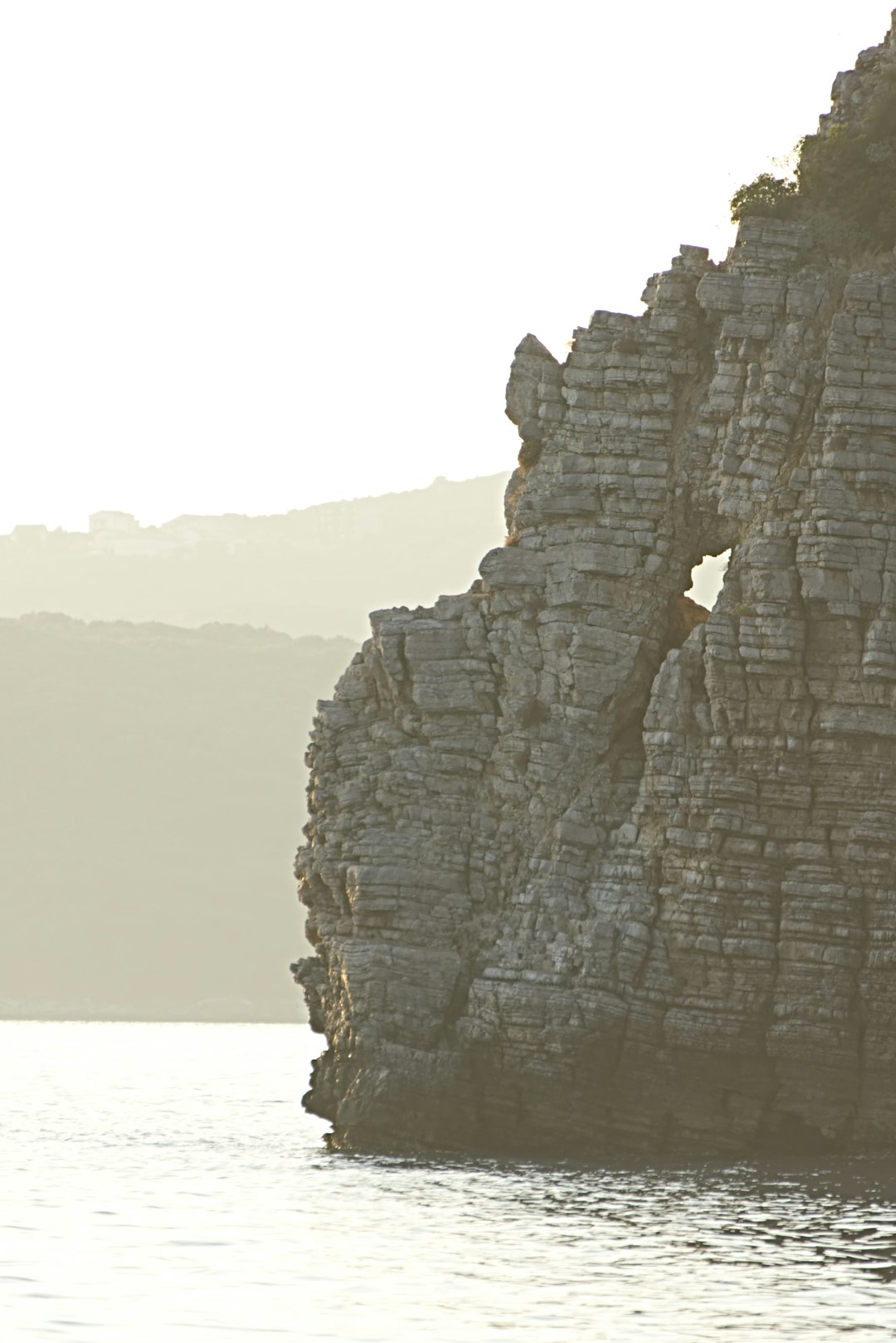 gray rock formation near body of water during daytime