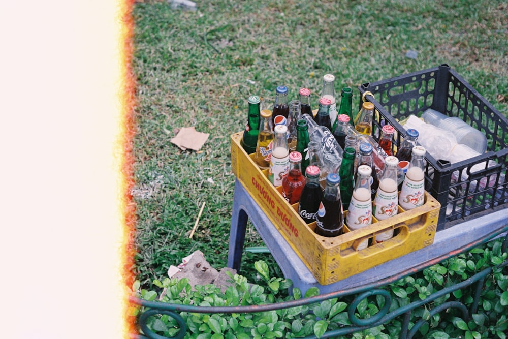 bottles on yellow wooden crate