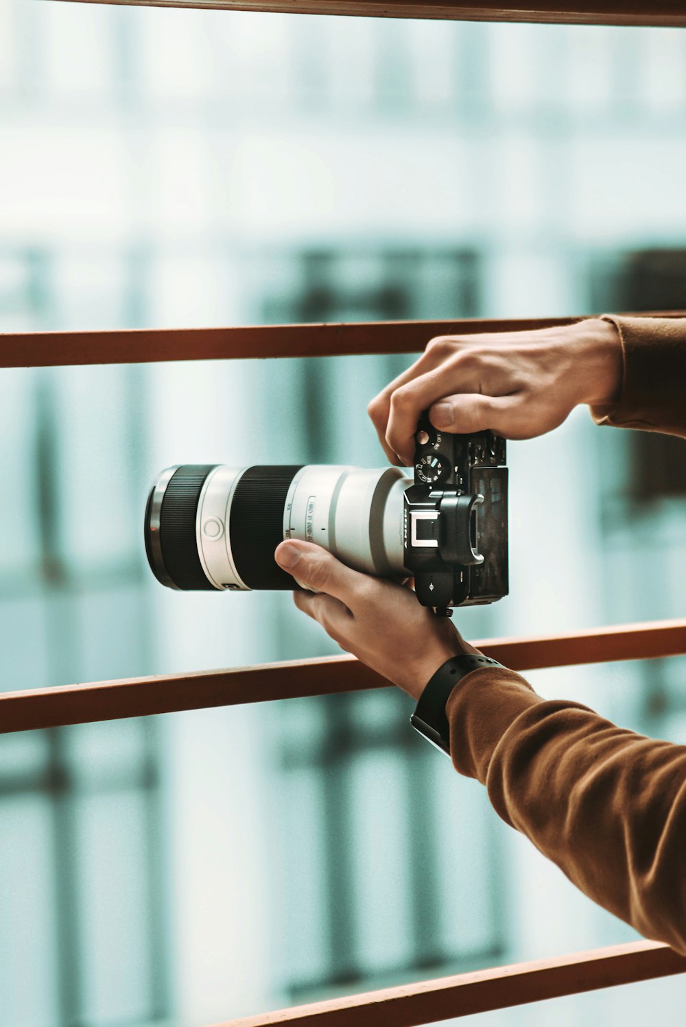 person holding black and silver dslr camera