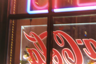 Close-up of a modern illuminated advertising sign on a storefront.