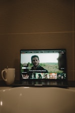 black flat screen tv turned on displaying man in black suit