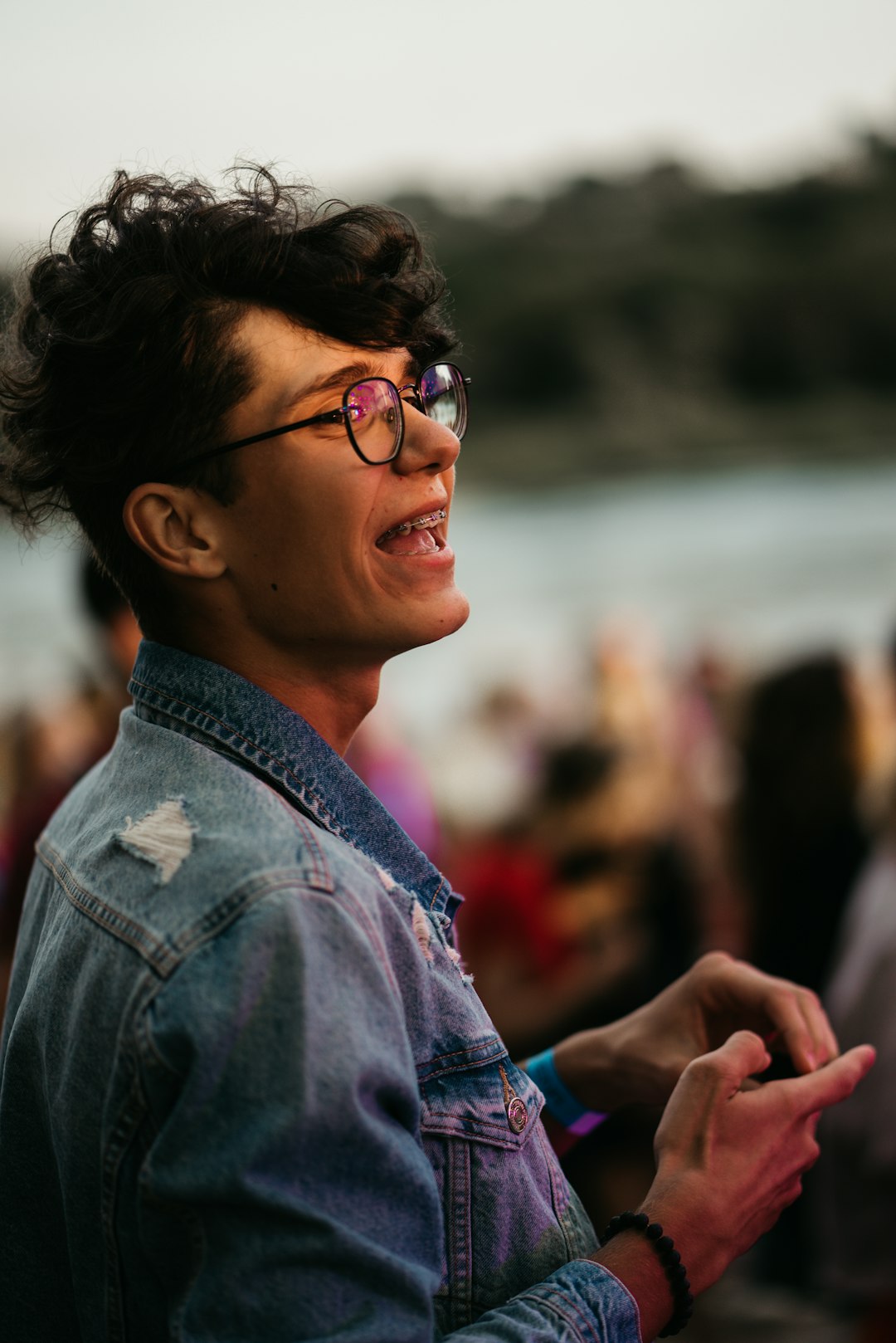 boy in blue denim jacket wearing eyeglasses