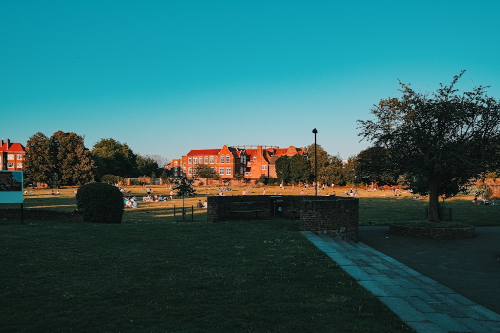 orange and black building near green trees under blue sky during daytime