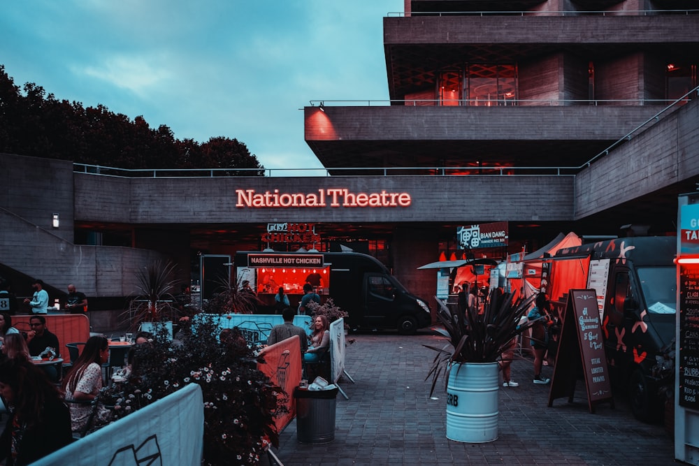 people standing in front of red and white building during daytime