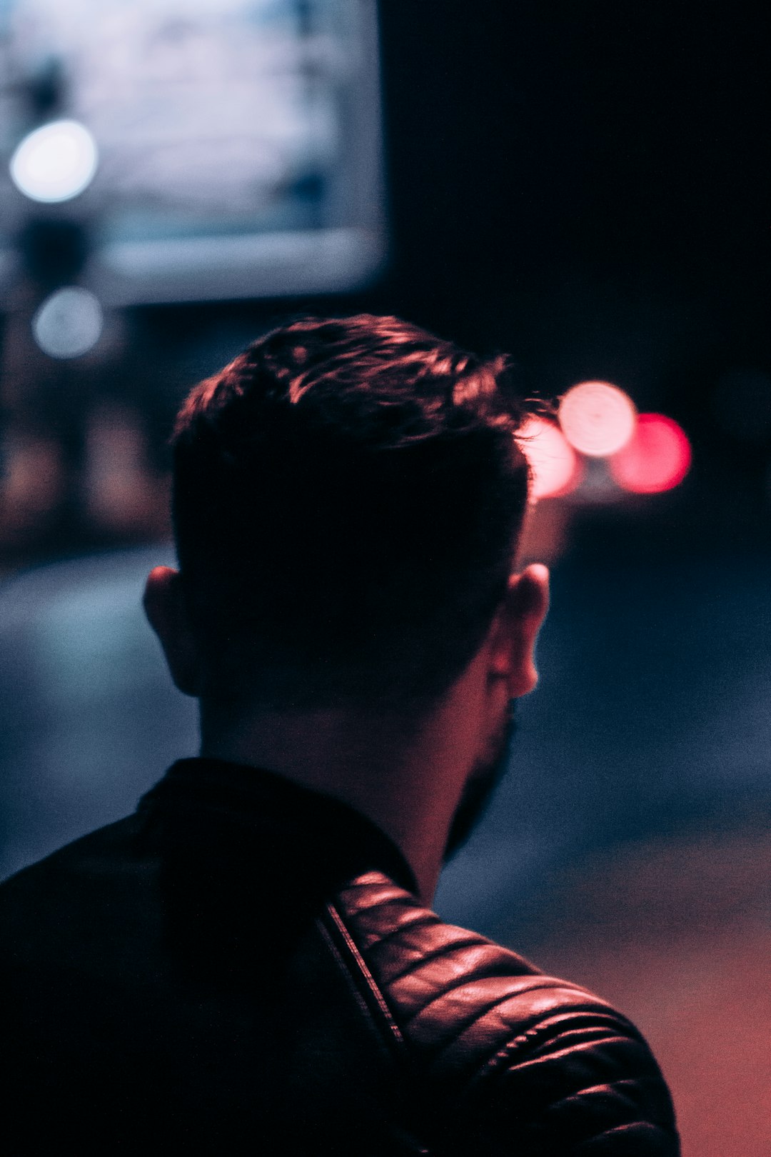 man in black shirt looking at the light