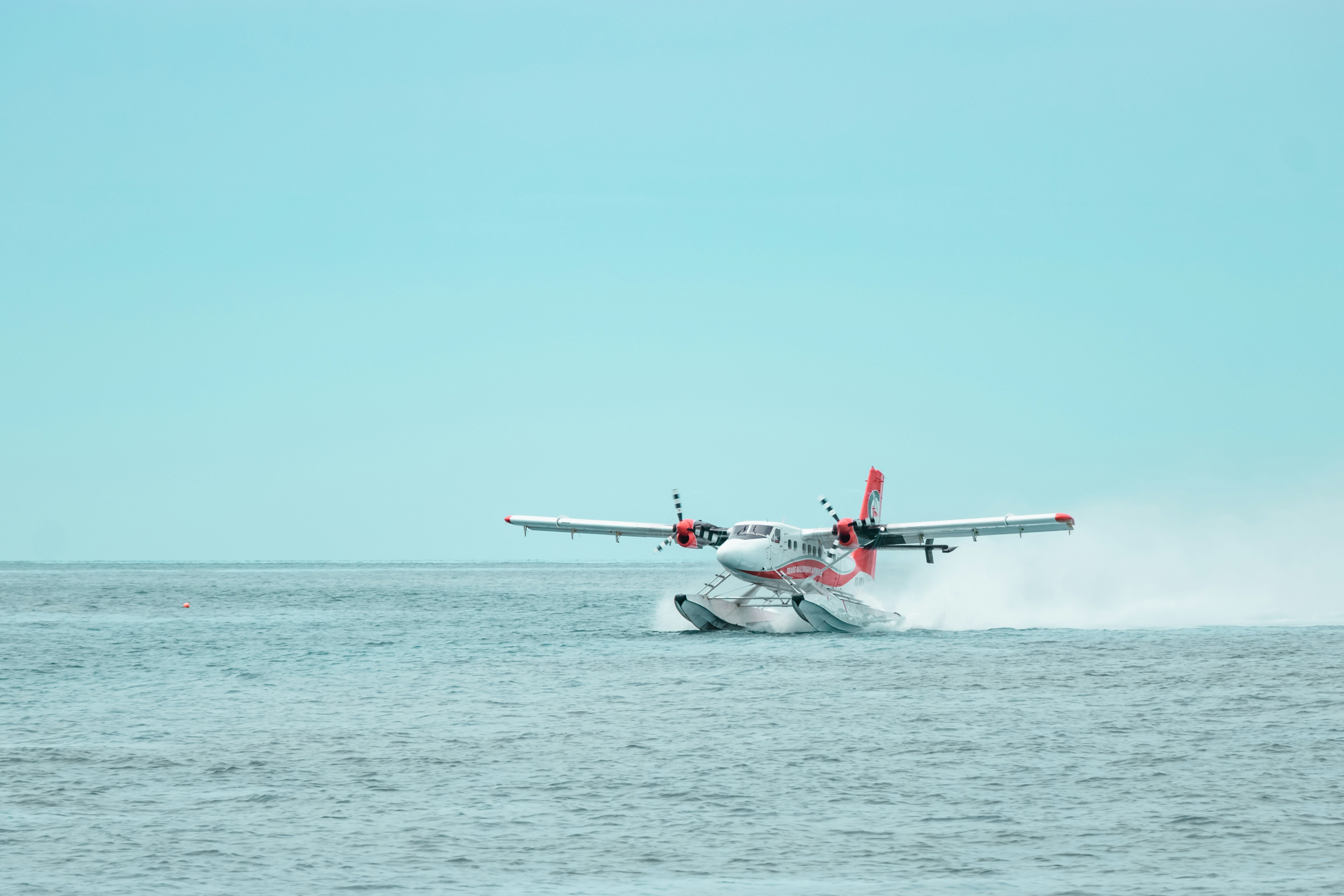 white and red jet plane in the sky, Trans Maldivian Airways