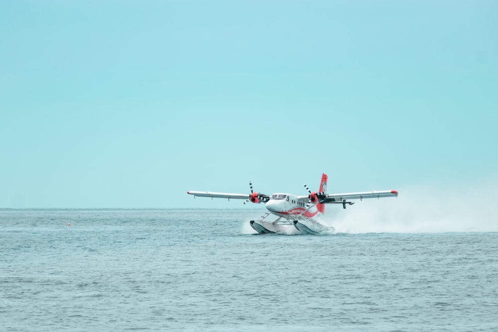 white and red jet plane in the sky