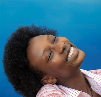 smiling girl in pink and white stripe shirt