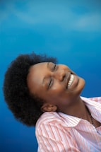 smiling girl in pink and white stripe shirt