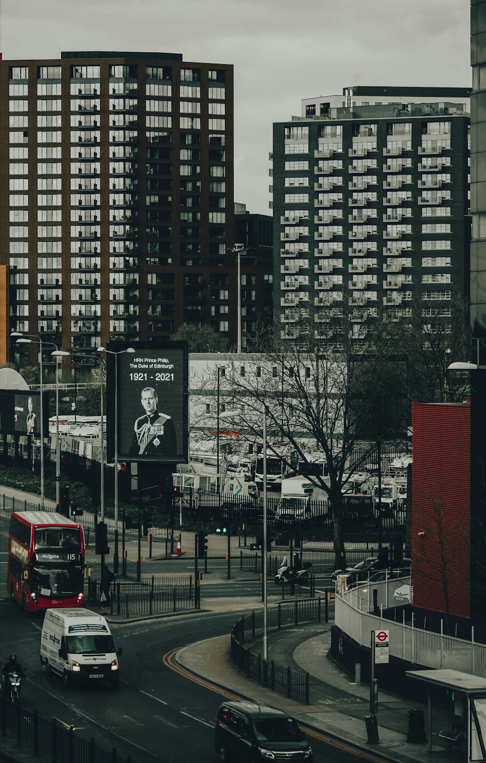 red bus on road near high rise building during daytime