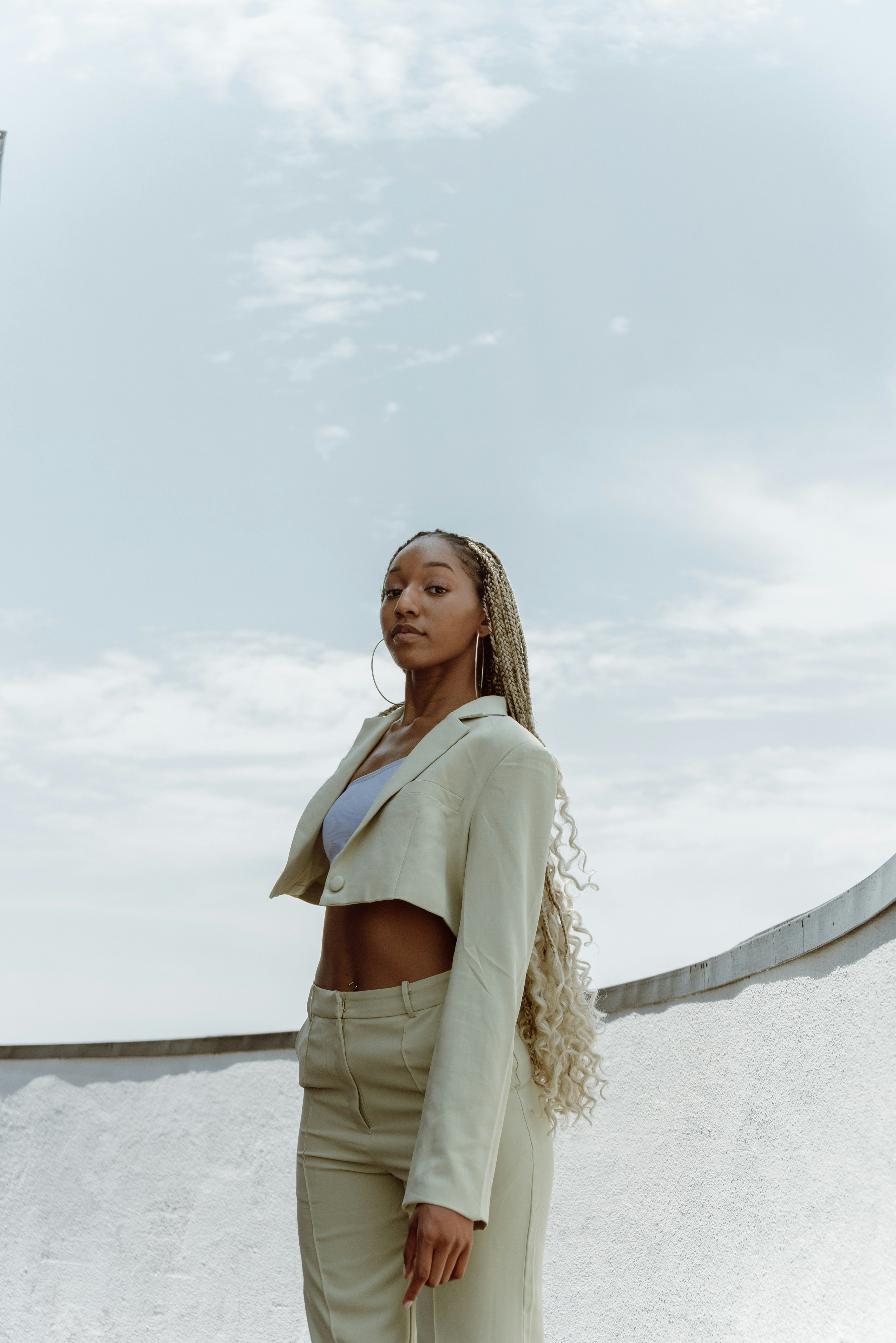 woman in yellow long sleeve shirt standing on beach shore during daytime