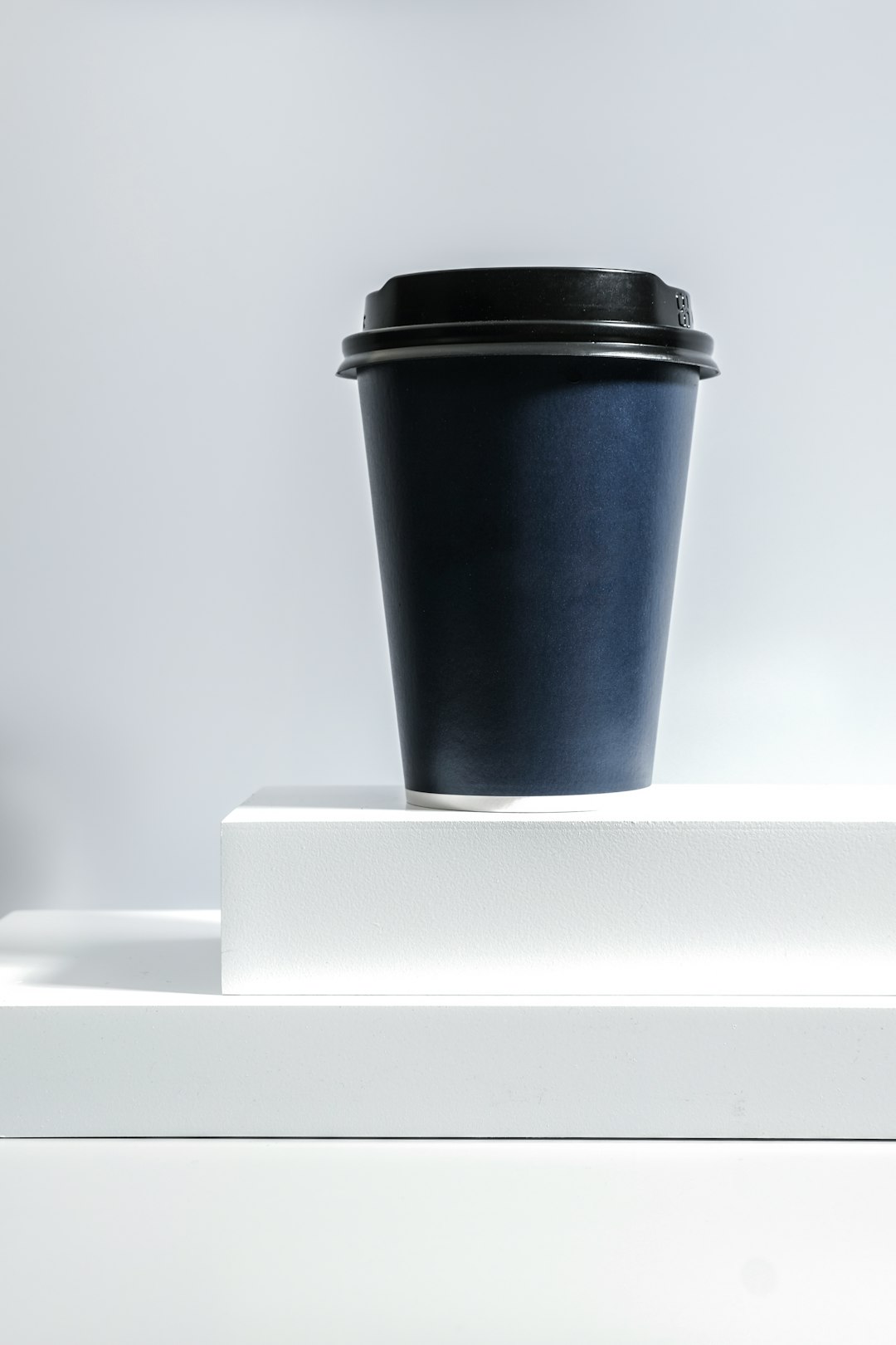 black and white coffee cup on white table