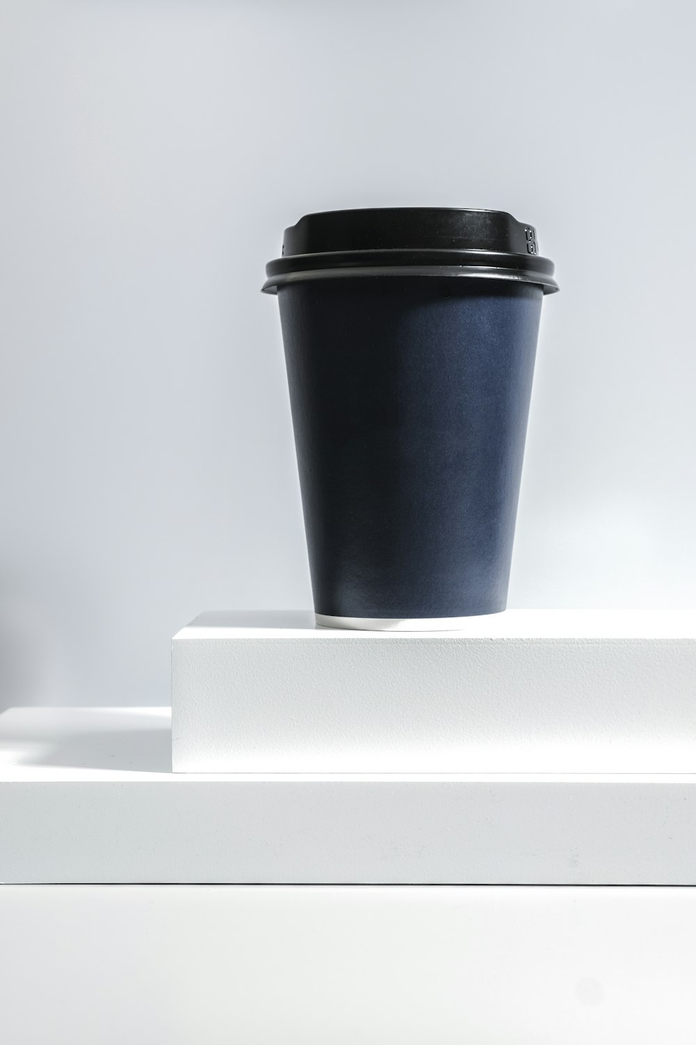 black and white coffee cup on white table