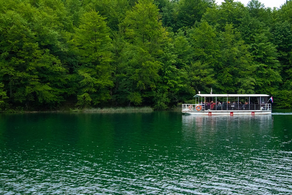 white and red boat on body of water during daytime