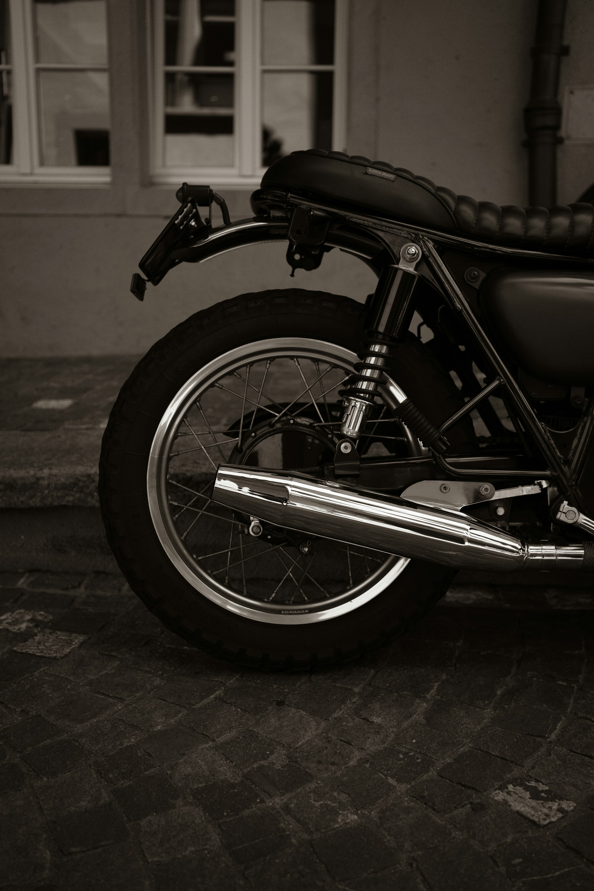 black and silver motorcycle parked on gray concrete floor
