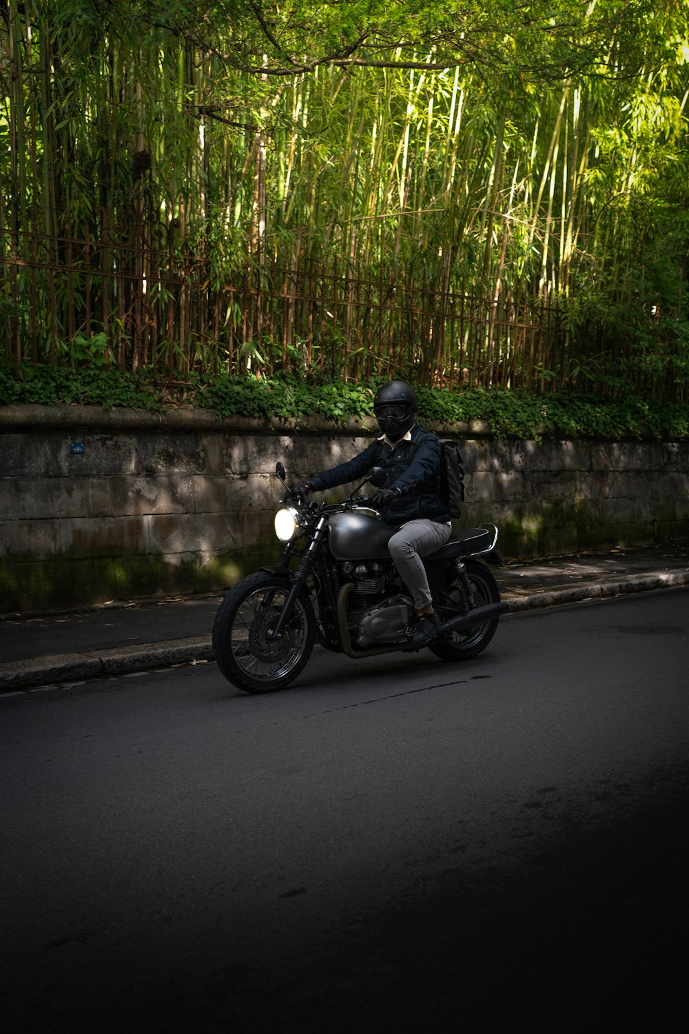 man in black jacket riding motorcycle on road during daytime