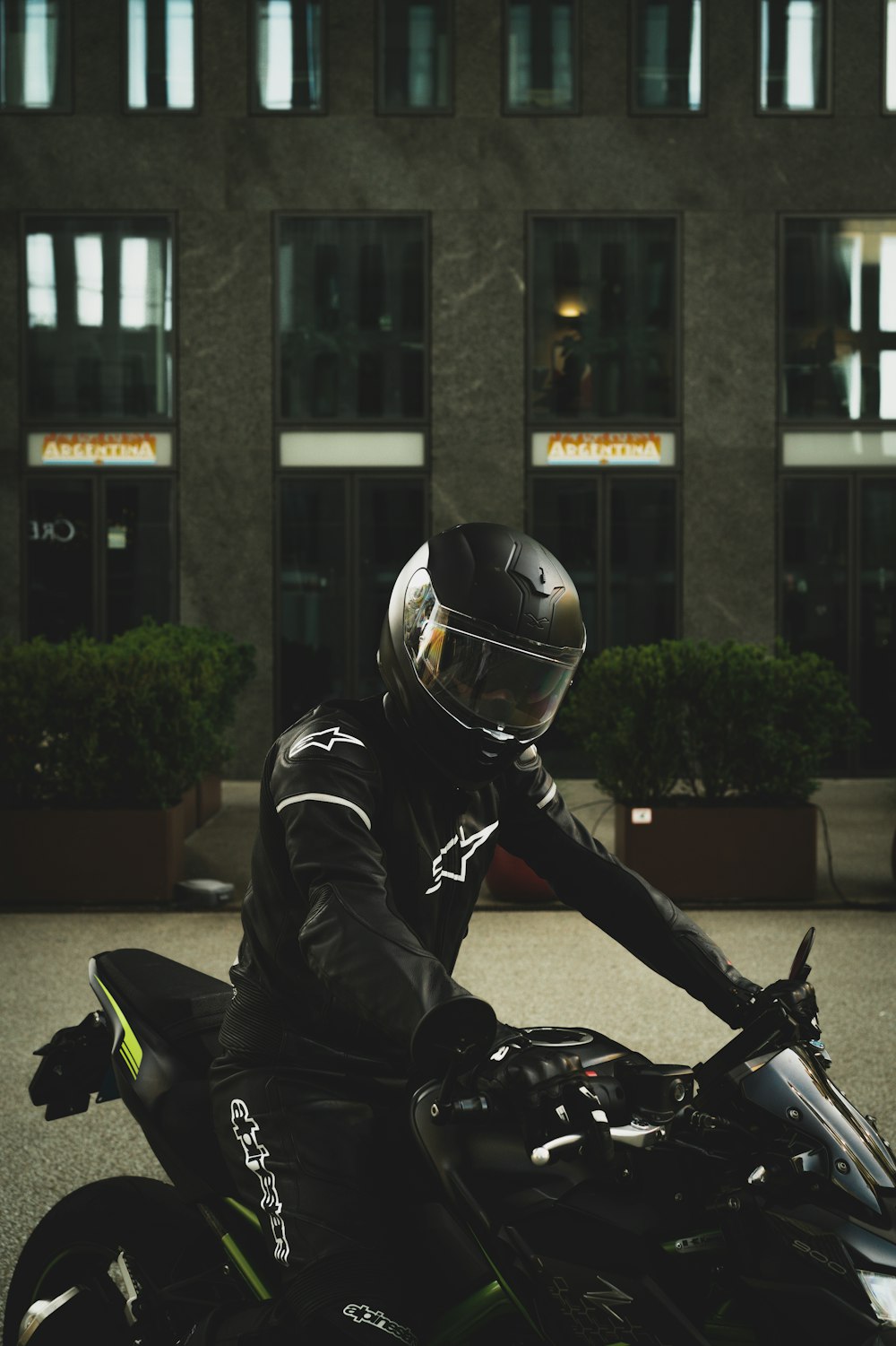 man in black leather jacket riding black motorcycle