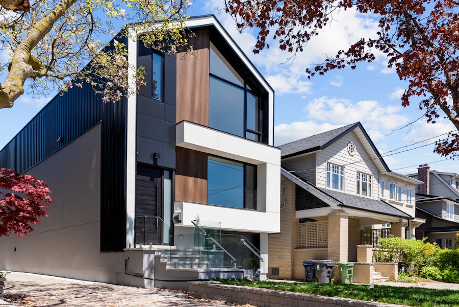 Contemporary home with black cladding and warm wood panels on an established street