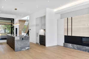 A bright, open-concept kitchen featuring sleek cabinetry and a large island in a custom home.