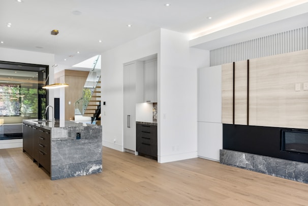 A sleek modern kitchen with minimalist cabinetry and a marble island
