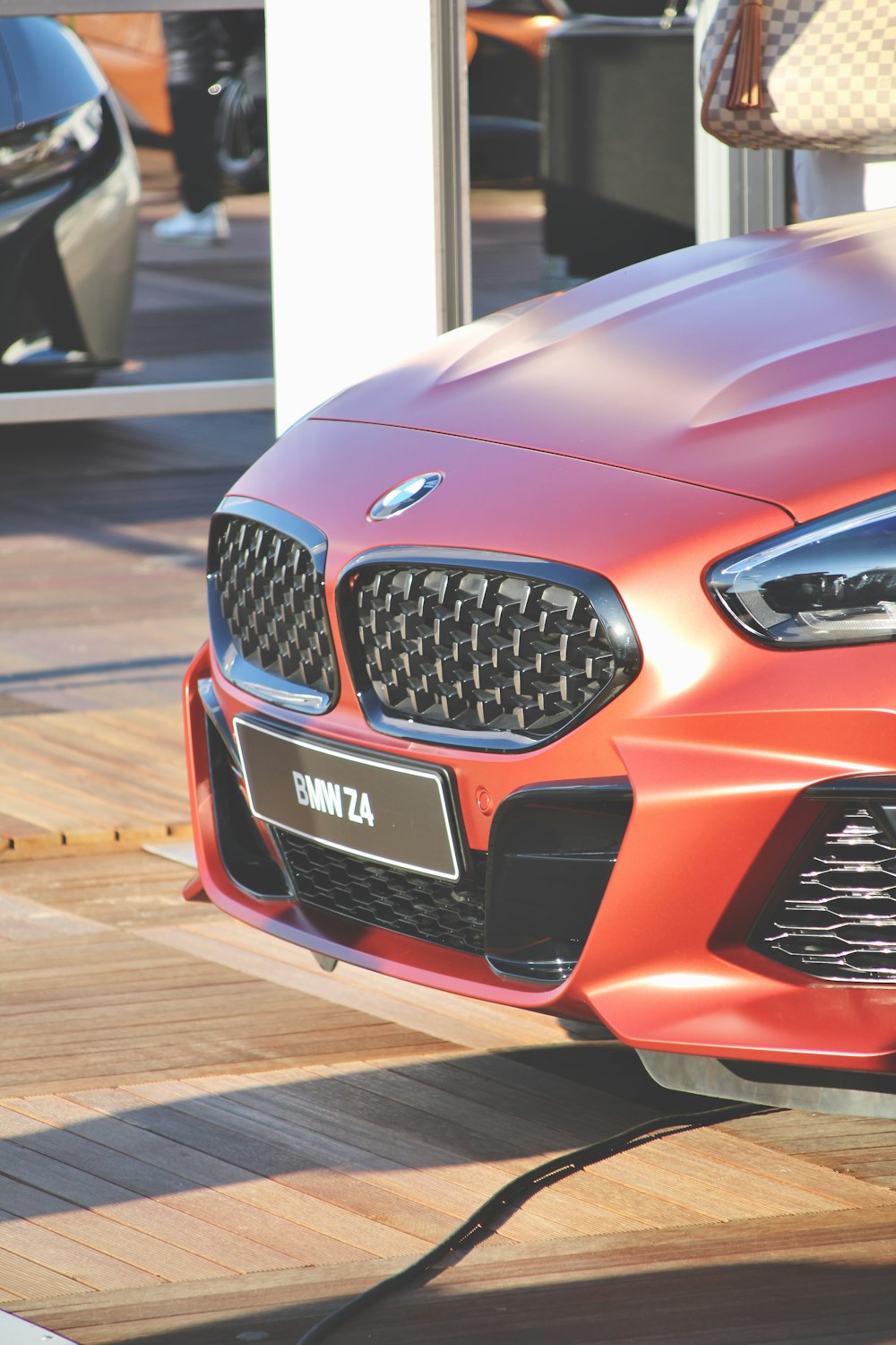 red and black car on brown wooden floor