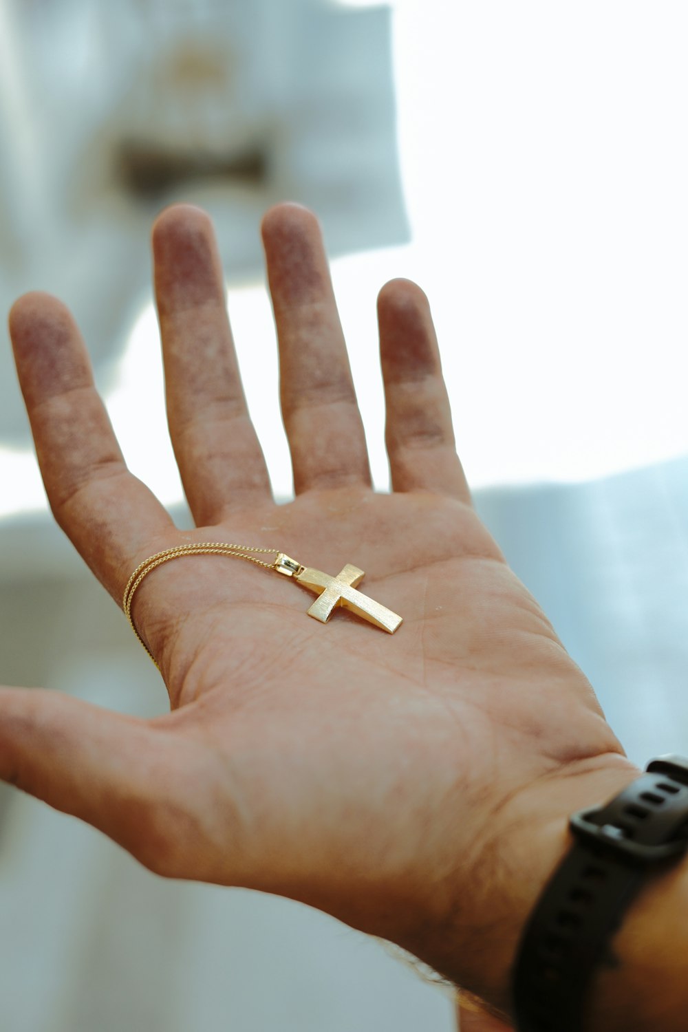 person wearing gold ring with white cigarette stick