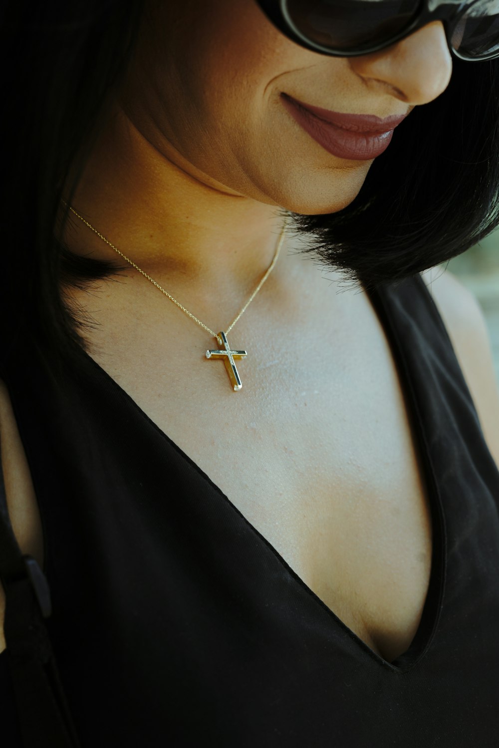 woman in black tank top wearing gold necklace