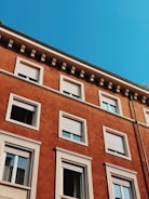 Exterior house facade freshly painted in warm earthy tones under clear skies.