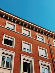 Exterior home facade freshly painted in warm earth tones under clear skies.