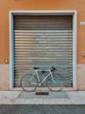 black and brown city bike parked beside brown wooden roll up door