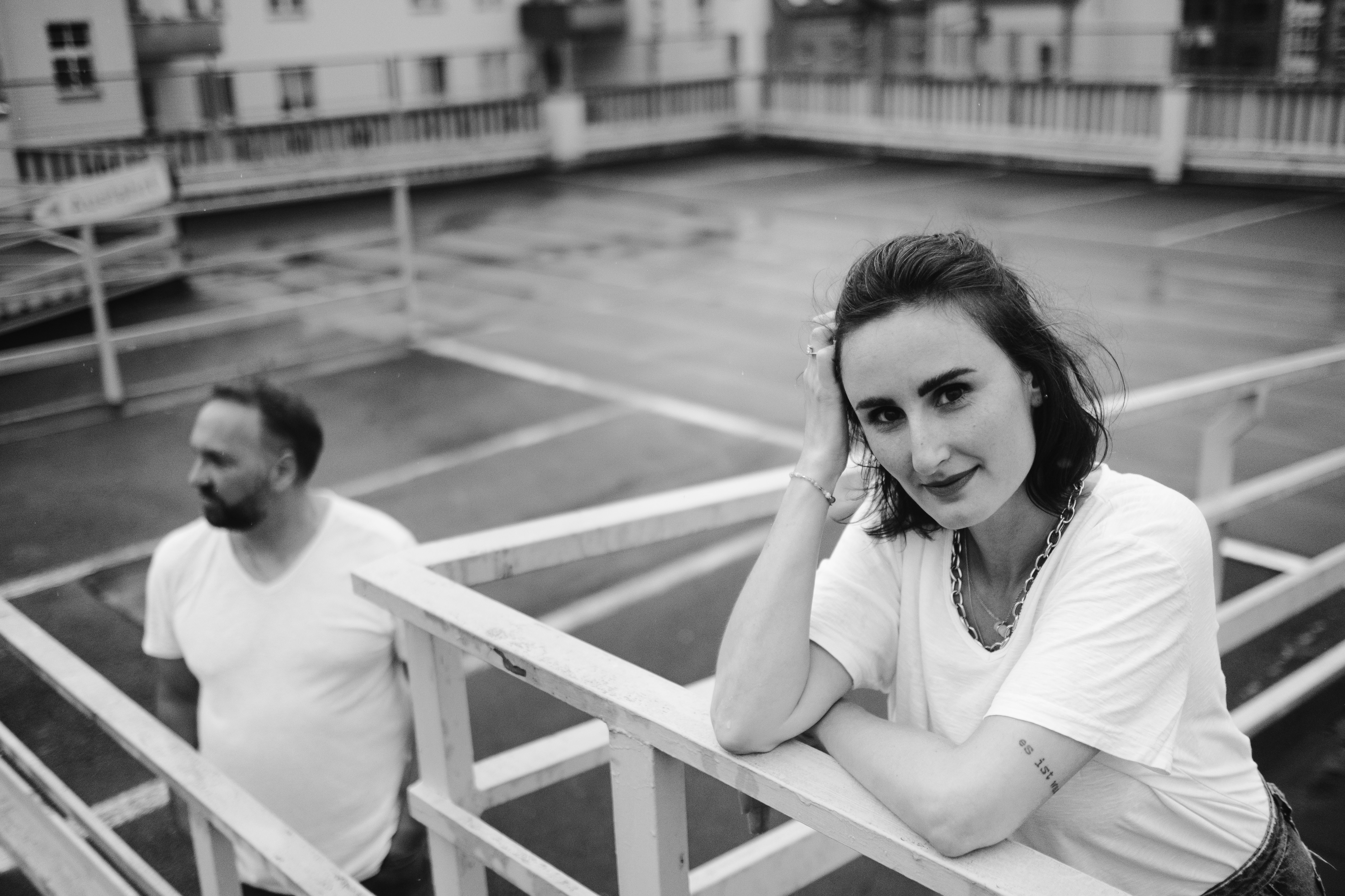 woman in white shirt sitting on white wooden bench