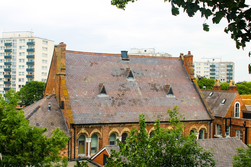 brown brick building near green trees during daytime