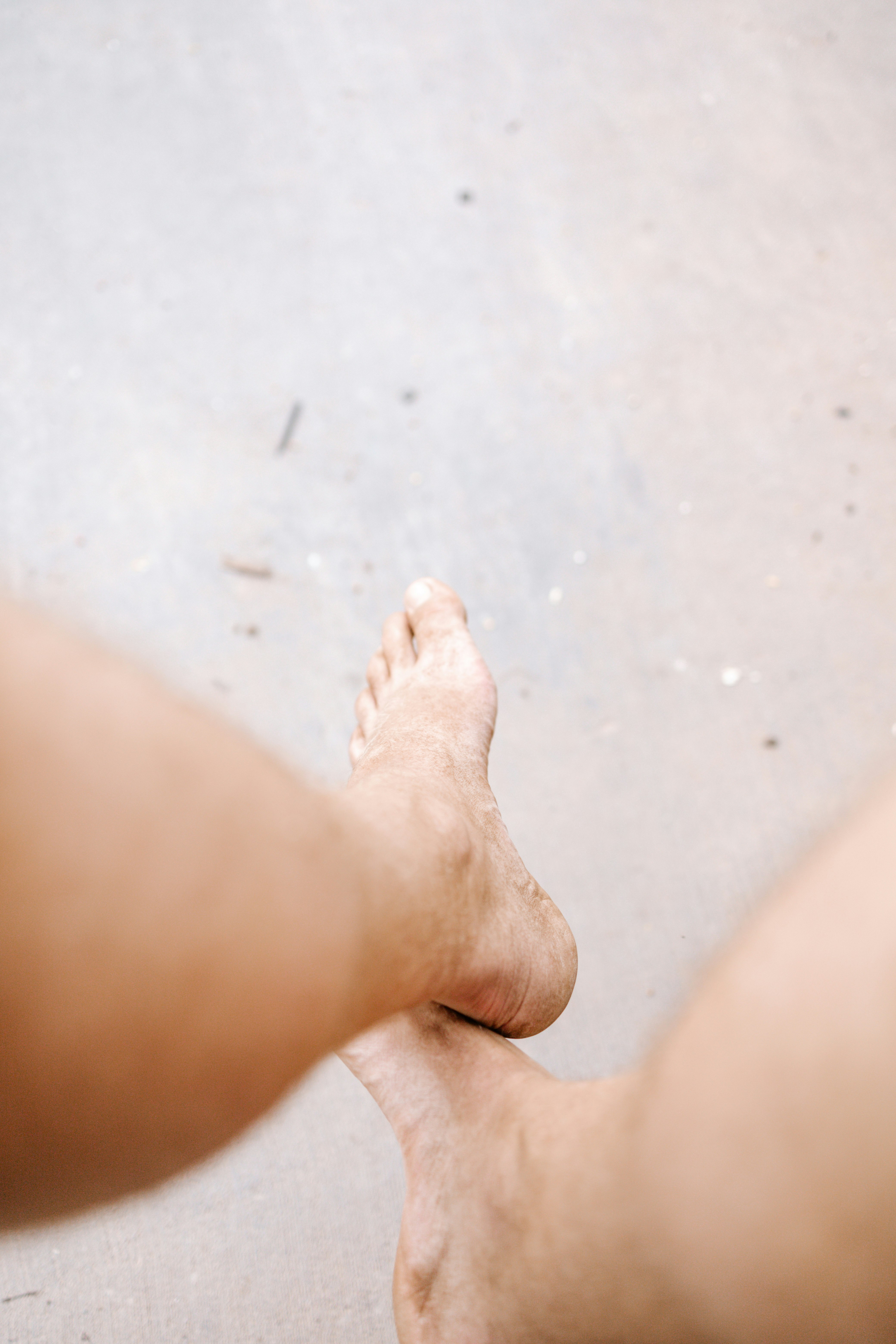 persons feet on gray concrete floor