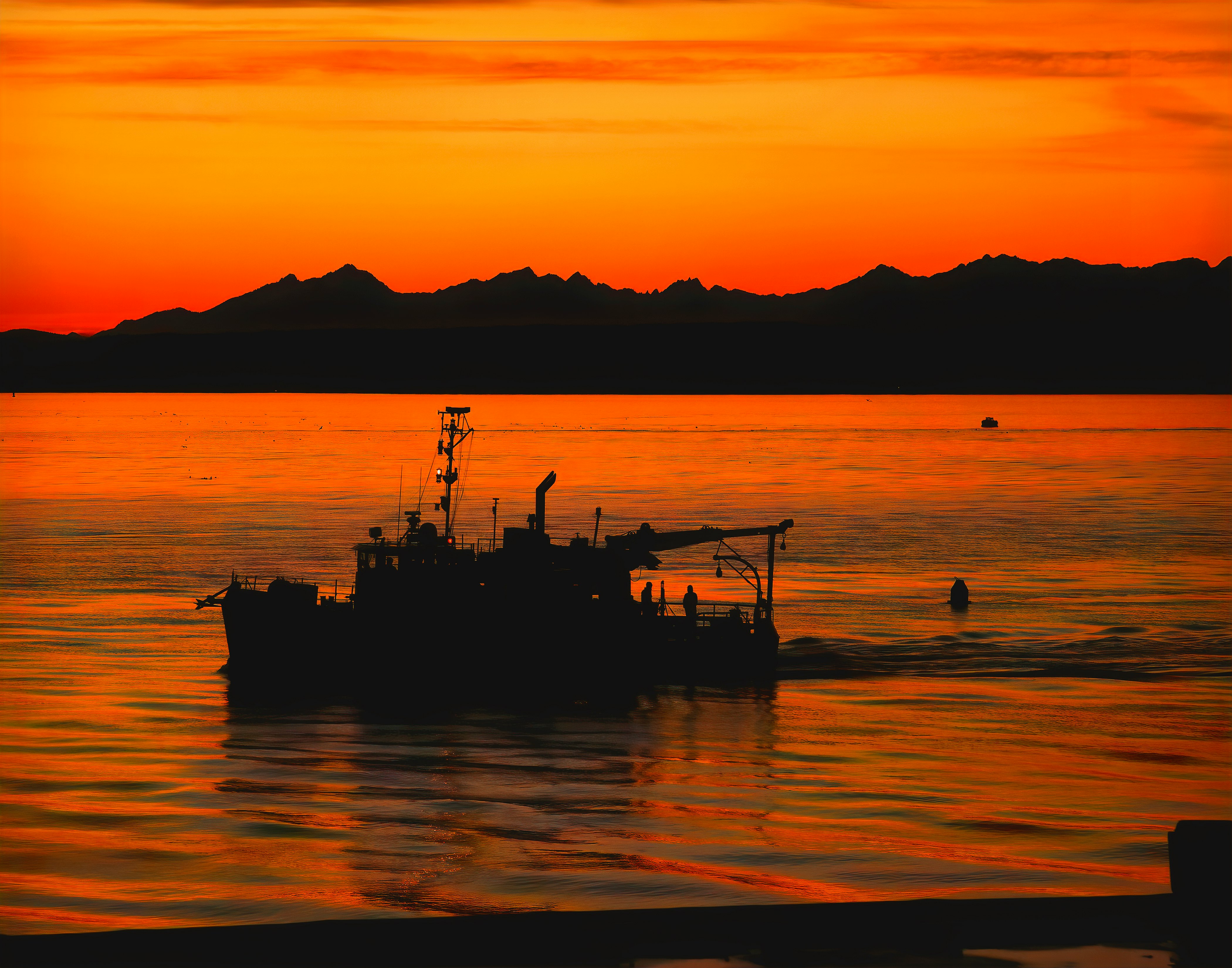 silhouette of boat on sea during sunset