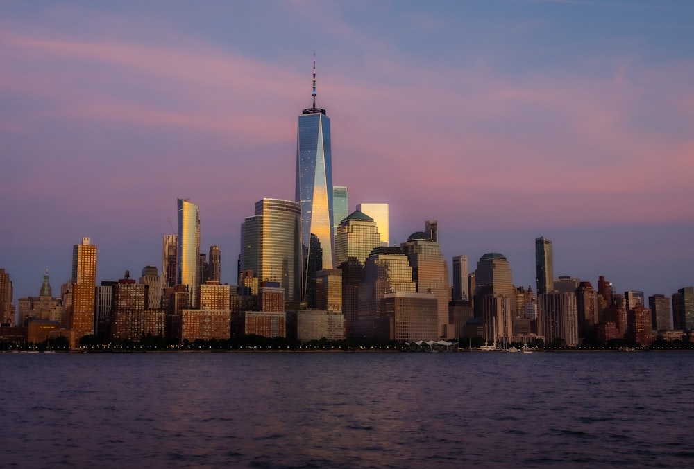 city skyline across body of water during daytime