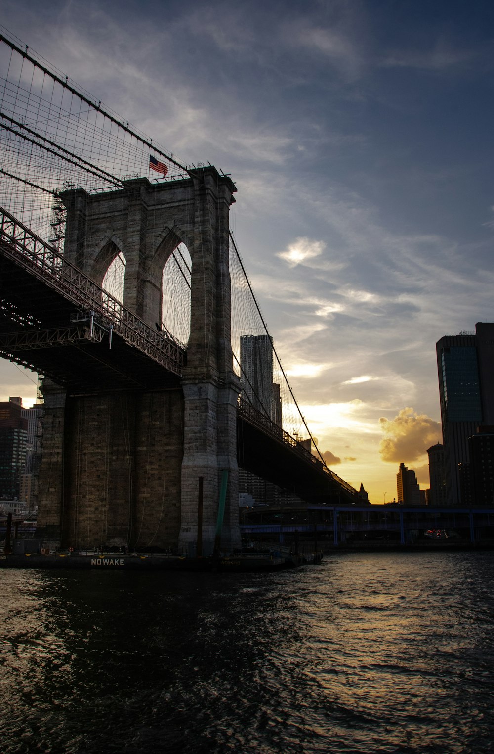 brown concrete bridge under cloudy sky during daytime