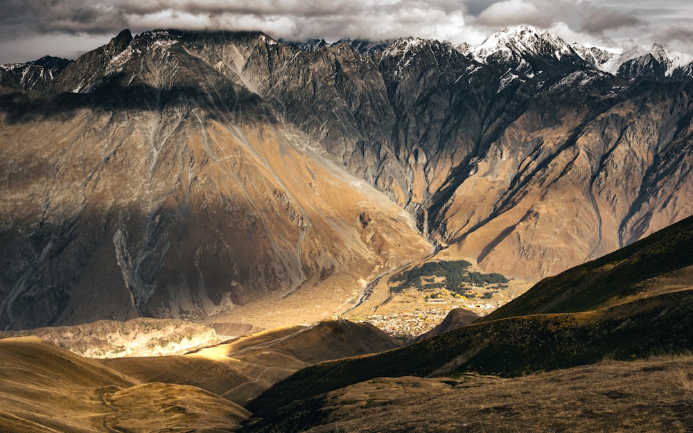 brown and white mountains under white sky during daytime