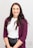 woman in red cardigan smiling