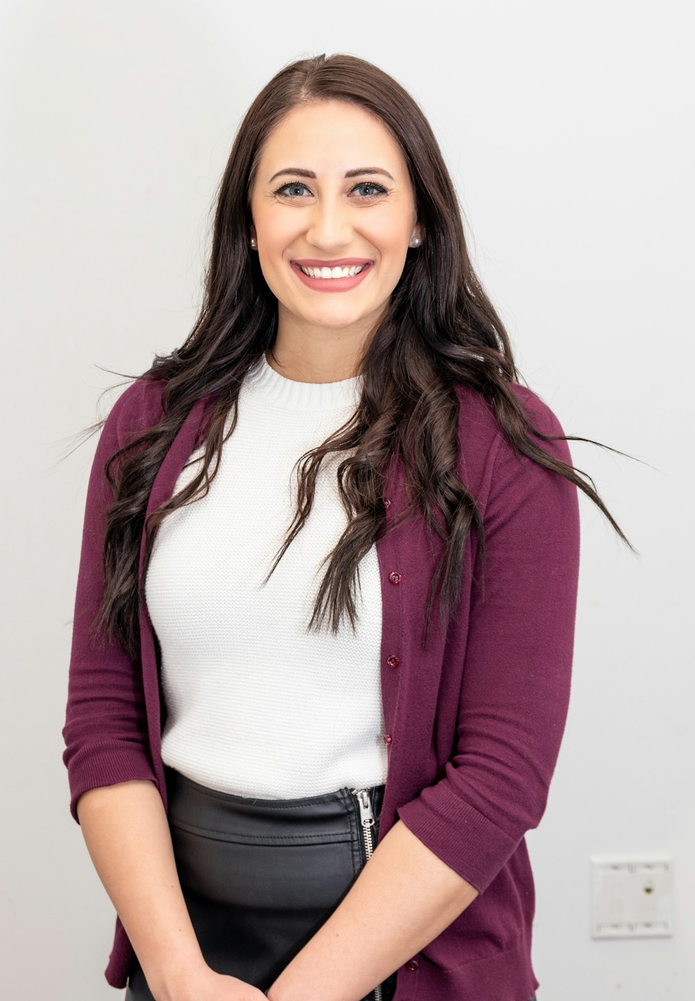 woman in red cardigan smiling