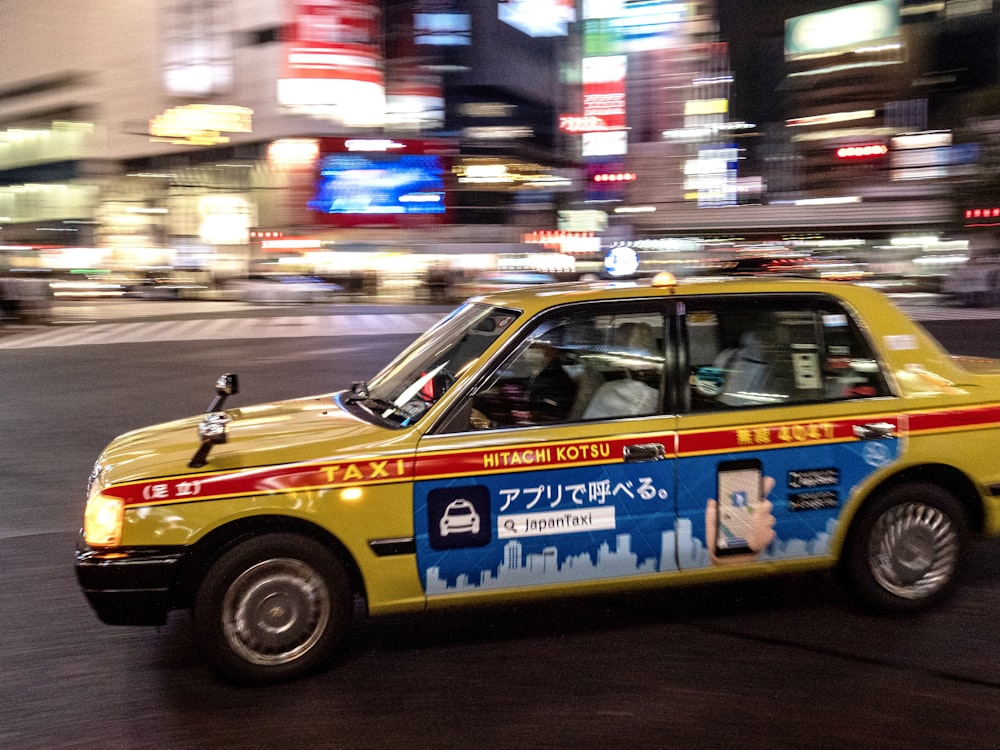 yellow and black taxi cab on road during night time