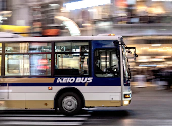 blue and white bus on road during daytime