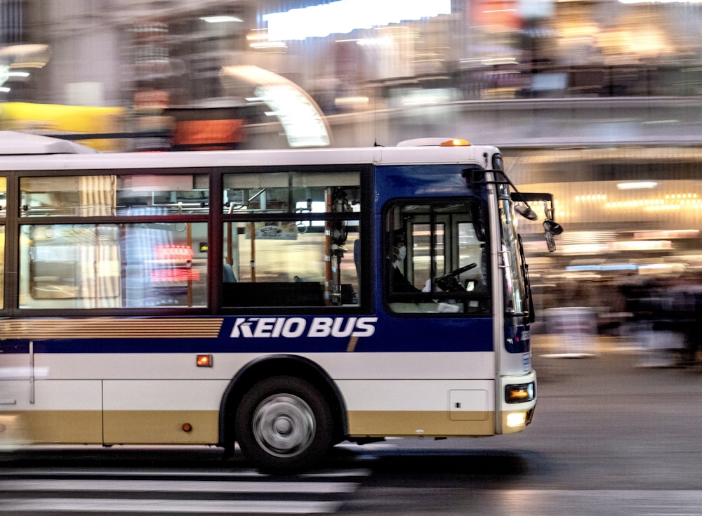 blue and white bus on road during daytime